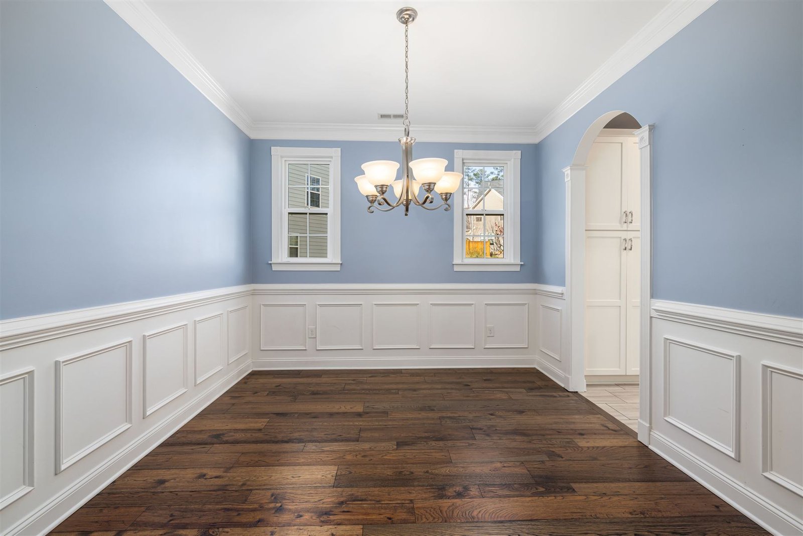 Freshly painted dining room with white wainscoting